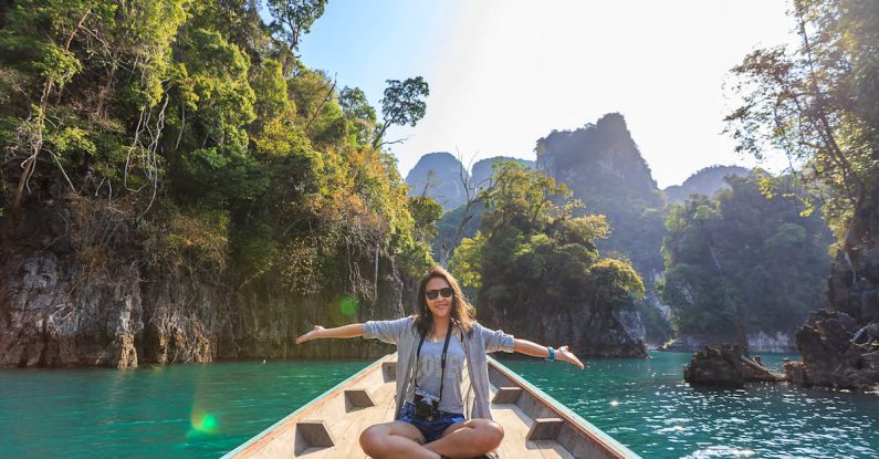 Tour - Photo of Woman Sitting on Boat Spreading Her Arms