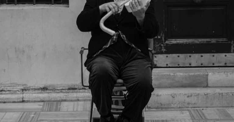 Comedy Festival - A man in top hat and cane playing violin