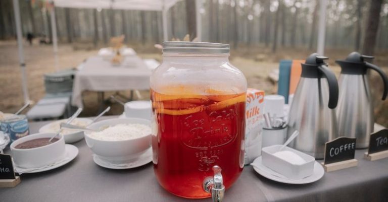 Camping Spots - A table with a pitcher of tea and coffee