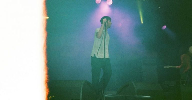 Film Festivals - Man in White Shirt and Black Pants Singing on Stage