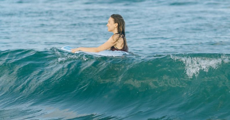 Surfing - Woman in Black Bikini Top in Water